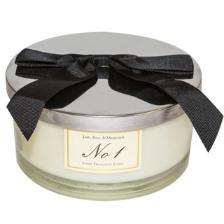 An Aldi jar candle with a white labels that reads "Lime, basil, and mandarin - No. 1 - Luxury fragranced candle".