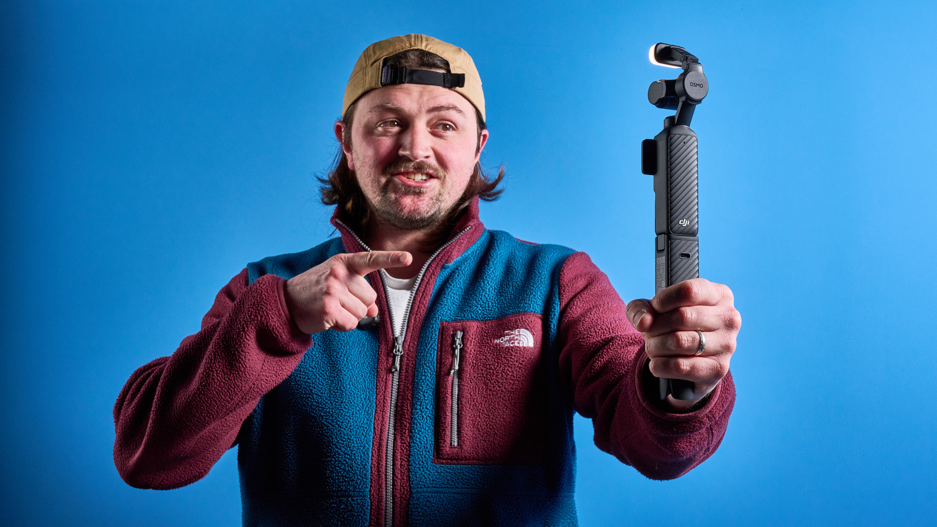 DJI Osmo Pocket 4 against a blue background