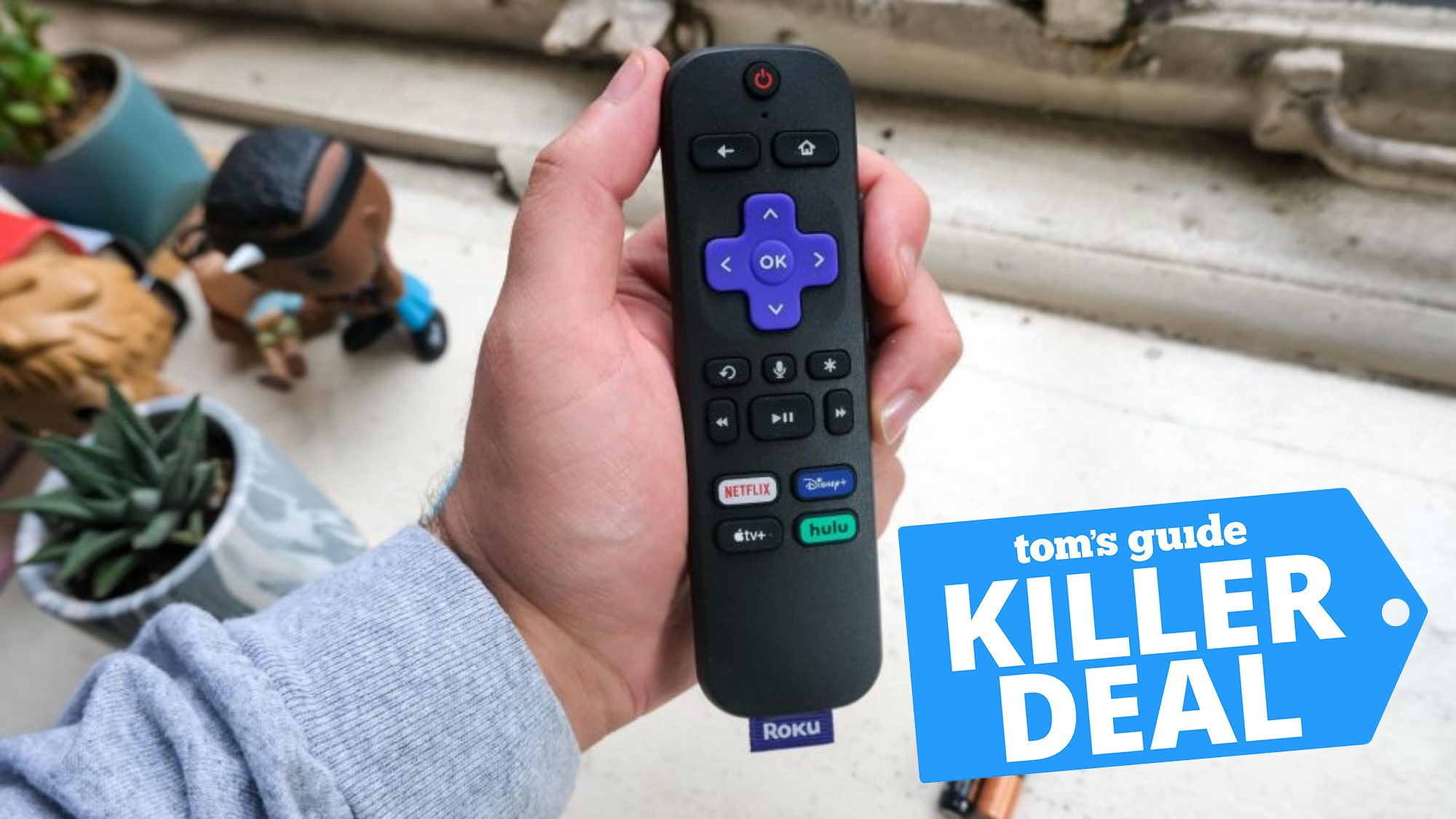 person holding Roku Streaming Stick 4K remote control