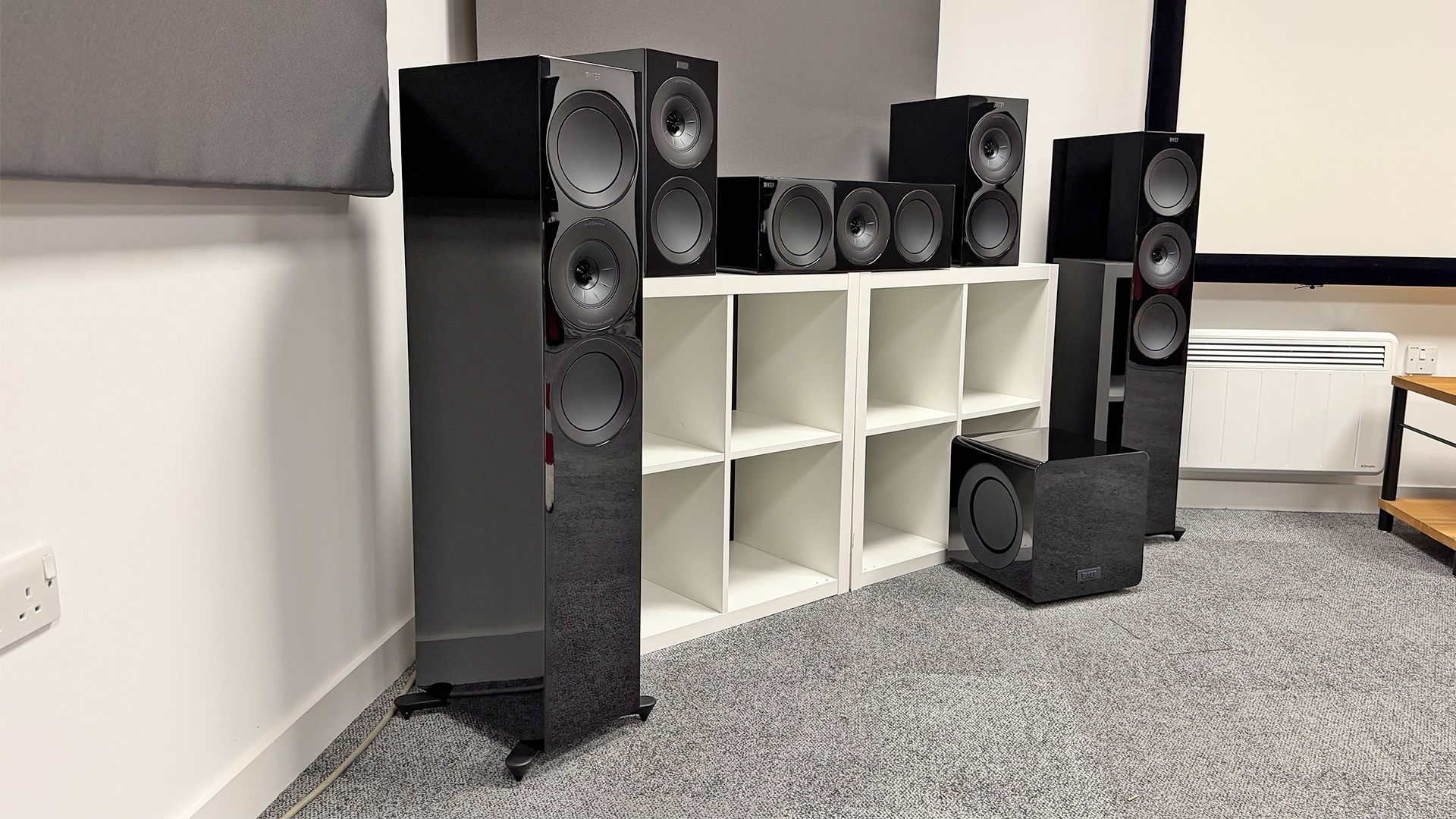 KEF R Meta 5.1 Speaker System speaker package in corner of grey carpeted test room