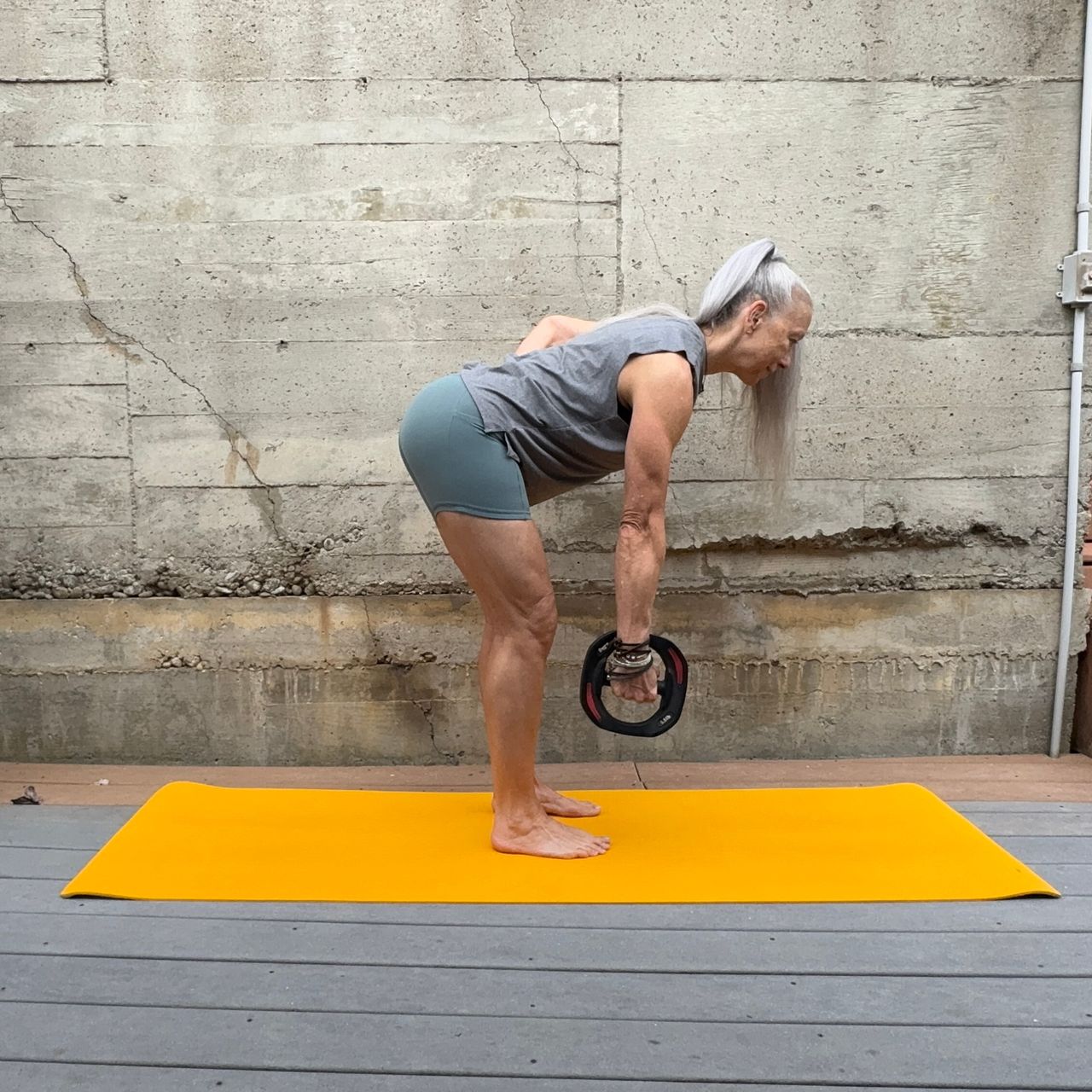 Woman exercising with weight plate