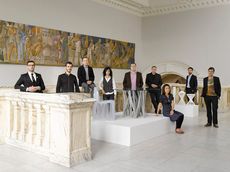 Group of people stood together in white room