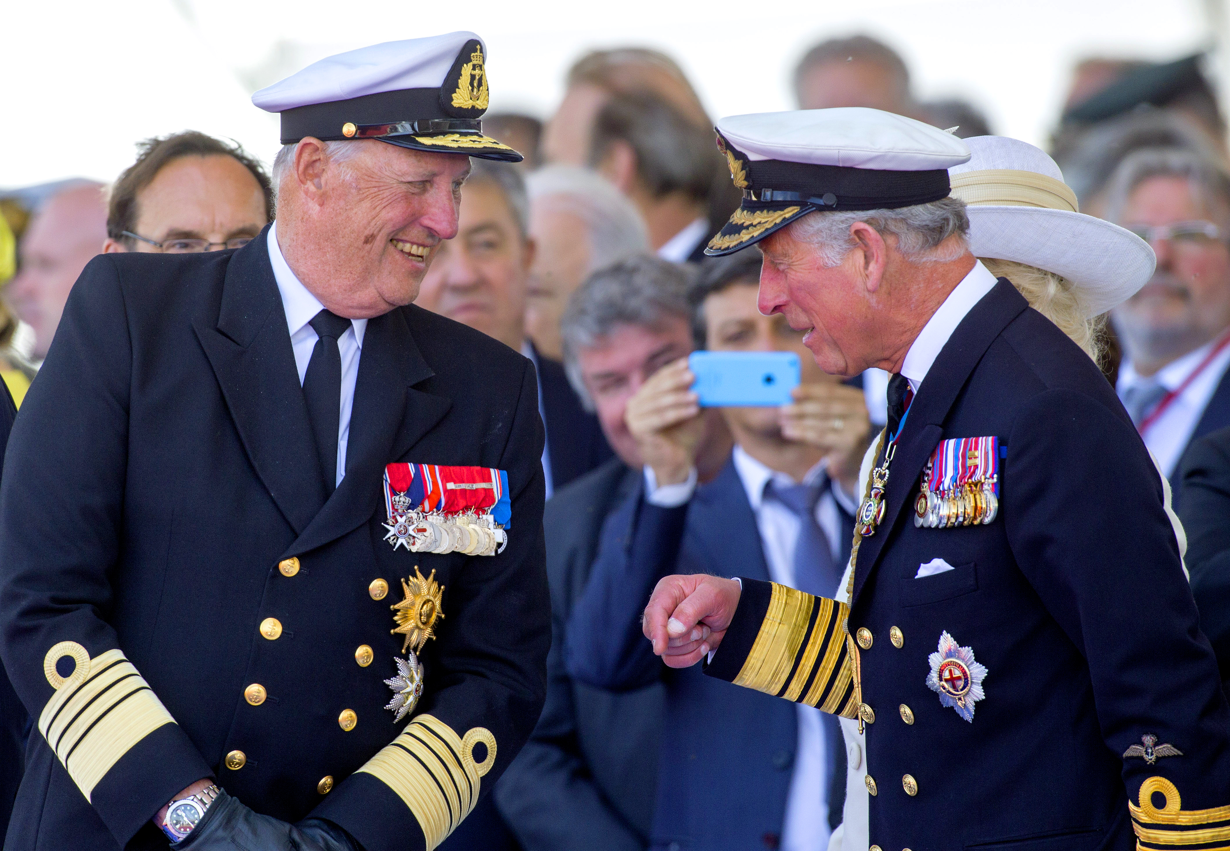 King Harald and King Charles wearing military uniforms and smiling at each other