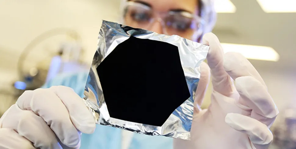 A black shape sits on a shiny background