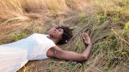 Cut grass perfumes - woman lying in grass field