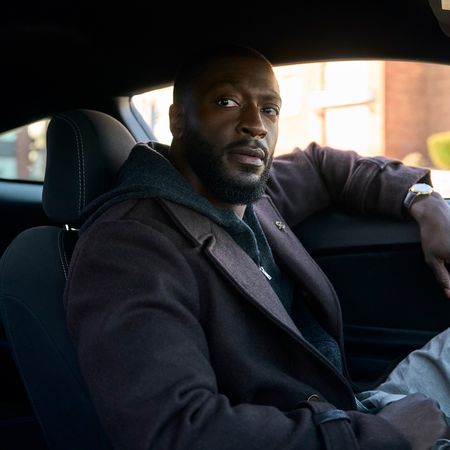 Aldis Hodge as Alex Cross, sitting in the front seat of a car, in 'Cross.'