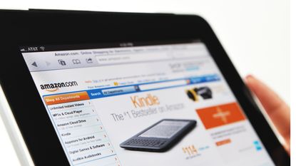  Woman Holding an iPad Displaying Amazon.com Web Site.
