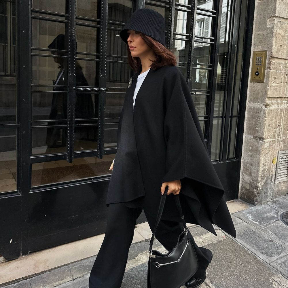 A woman in Paris wearing a stylish, all-black winter outfit