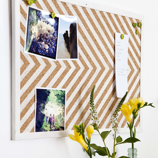 noticeboard with photos and flower vase