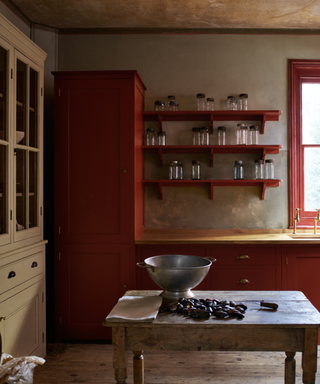 red english country kitchen with a rustic freestanding kitchen table island