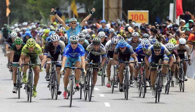 Andrea Guardini and an Astana teammate raise their arms after the win