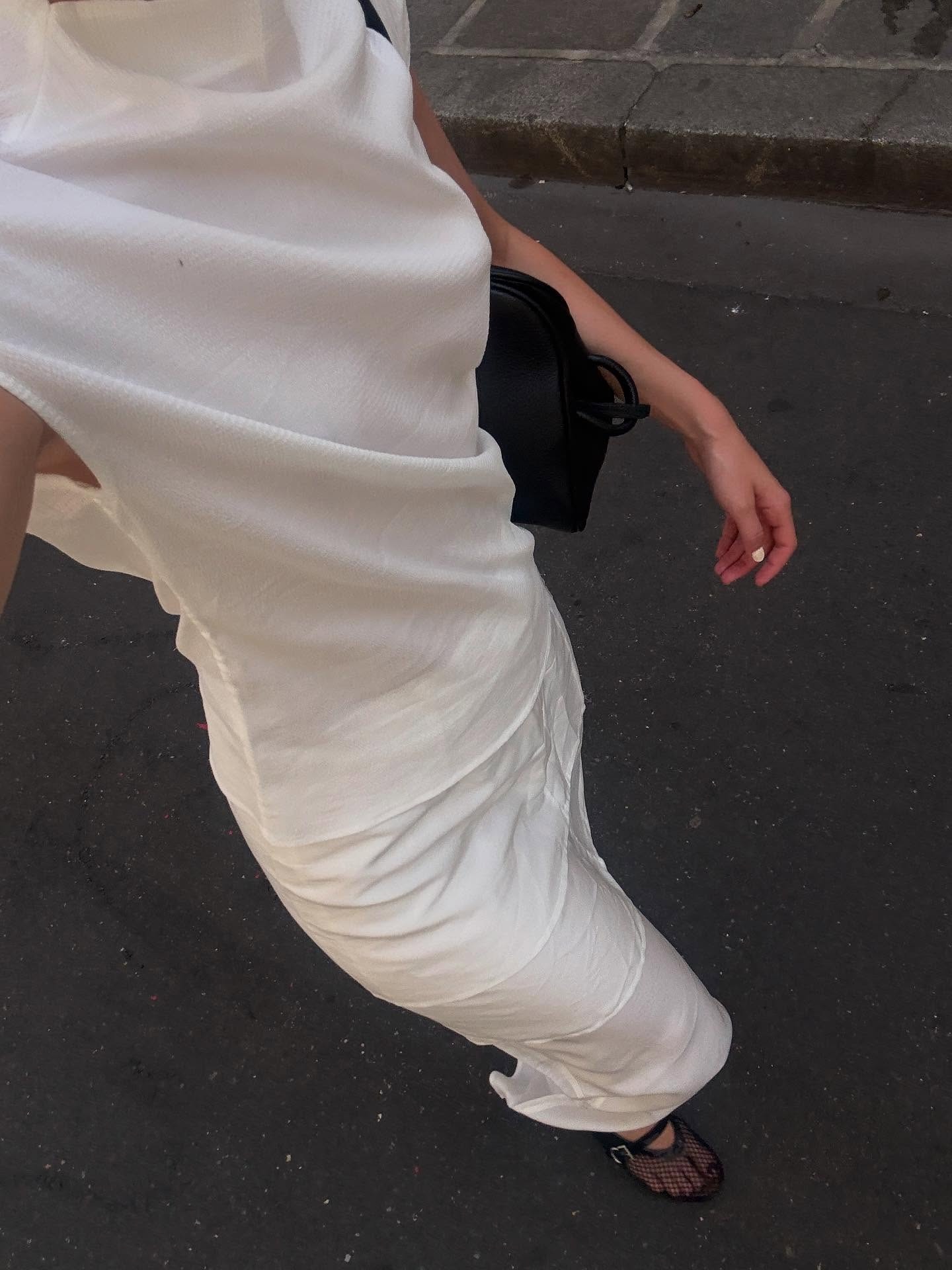 Christie wears a silk top and slip skirt.