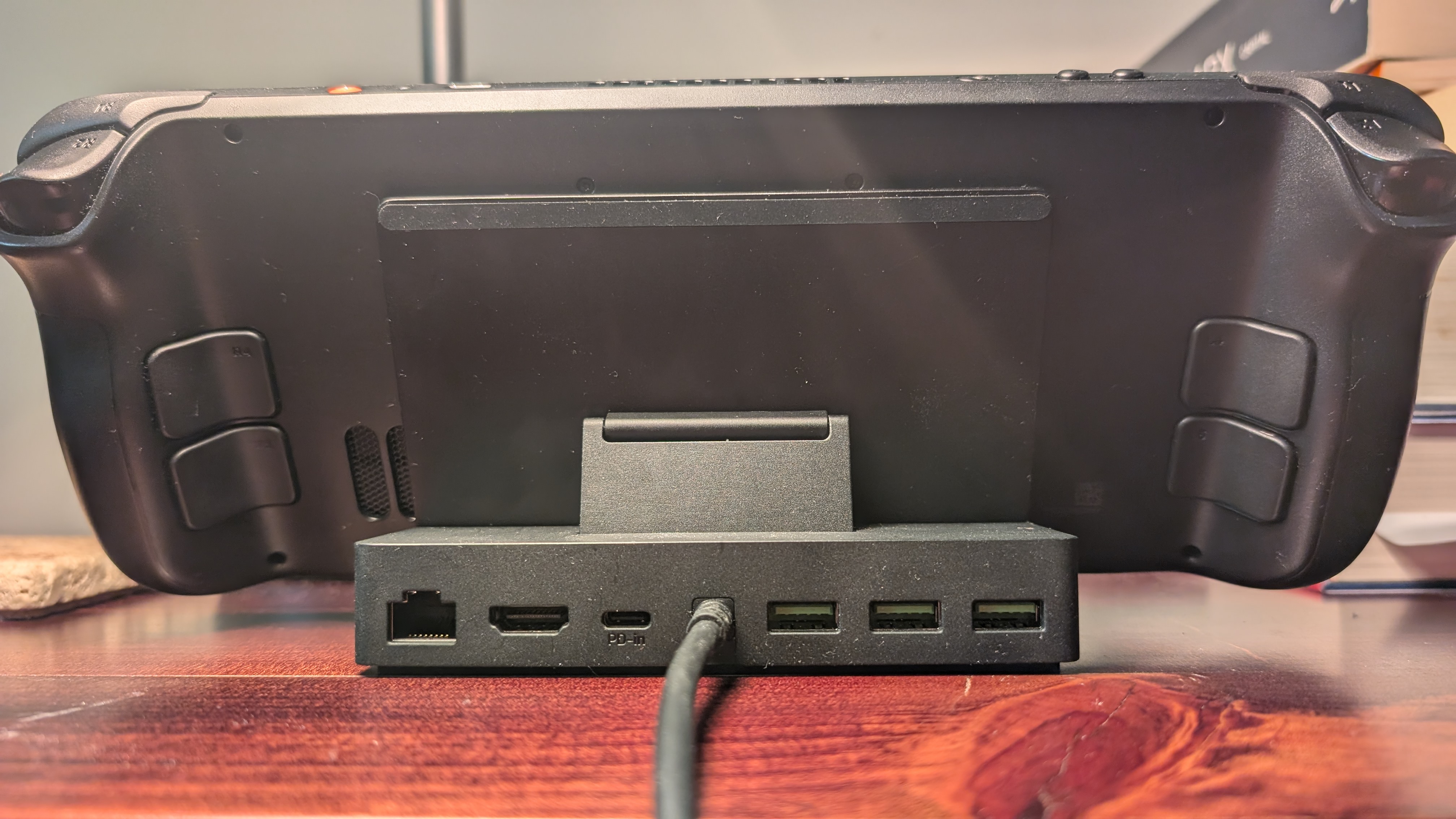 Razer Handheld Dock Chroma shown blocking the rear vents of the Steam Deck OLED