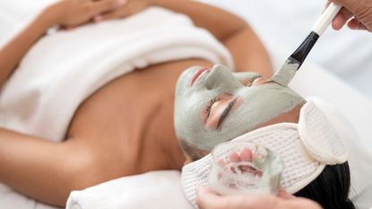 woman having a facial applied at a beauty salon