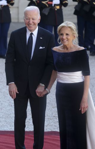 Joe Biden and Jill Biden stand together at the French state dinner where Dr. Biden wears Schiaparelli