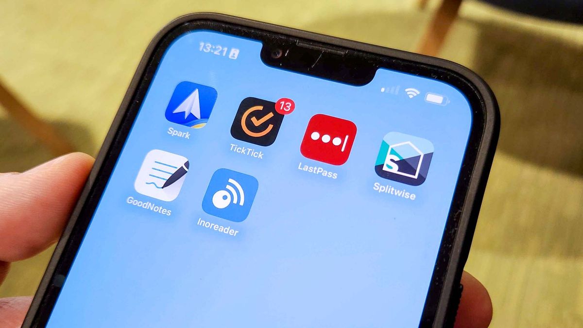An iPhone 13 Pro Max with a home screen showing Spark, TickTick, Lastpass, Splitwise, Goodnotes 5 and Inoreader