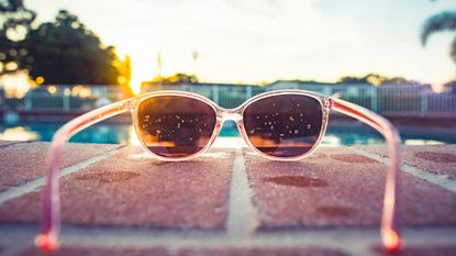 Sunglasses frame a pool scene.