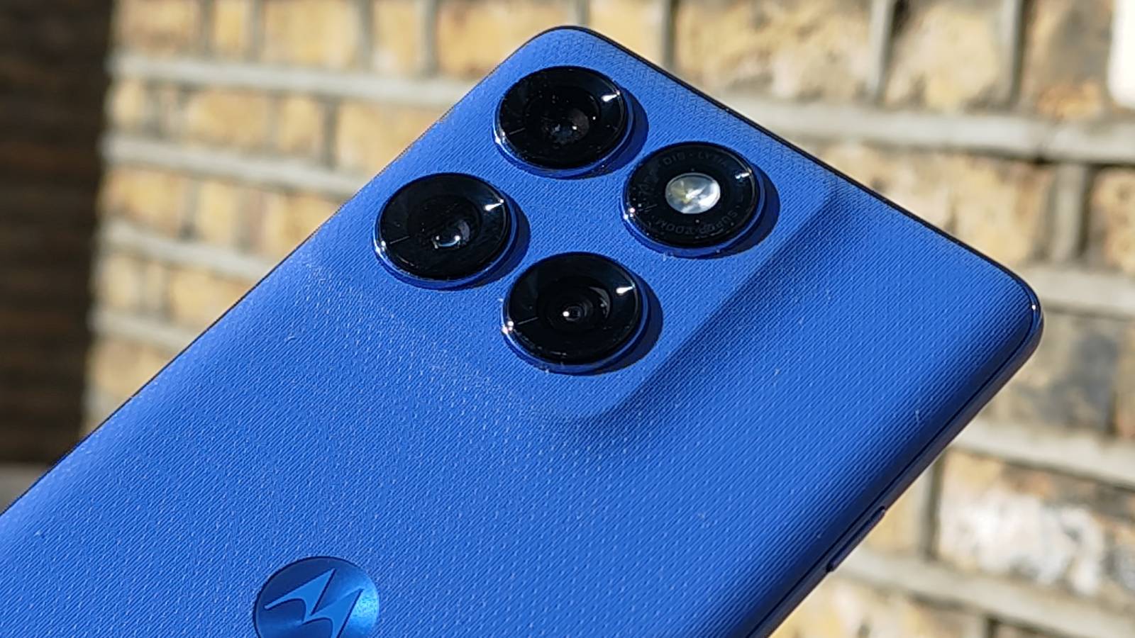The Motorola Edge 60 Pro above a brick wall.