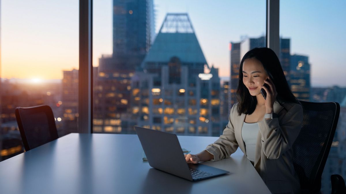 asian woman using laptop at business table