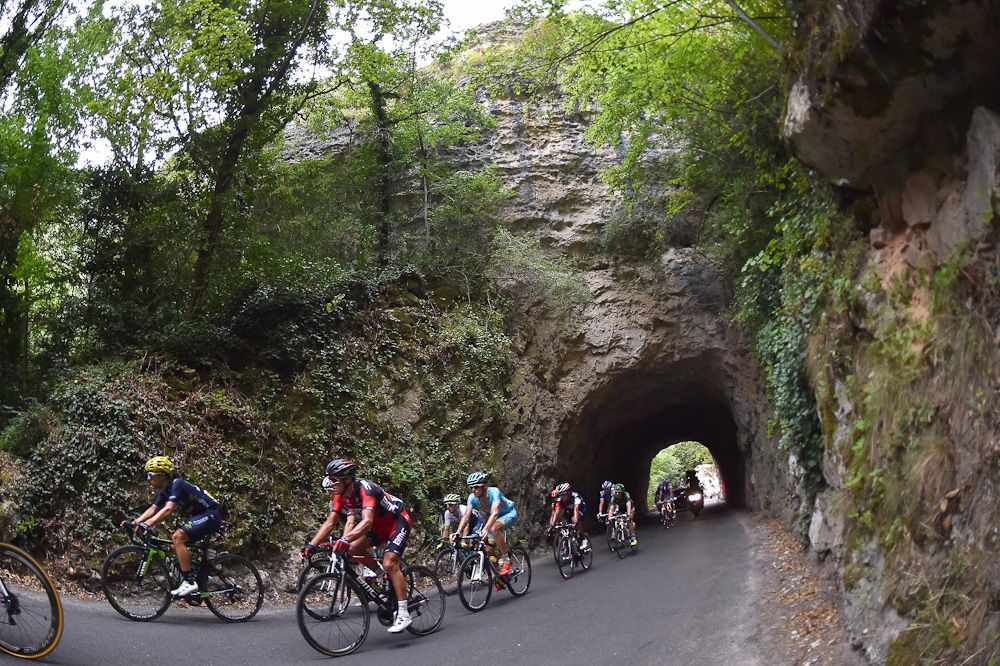 The breakaway emerges from a tunnel during stage 14.