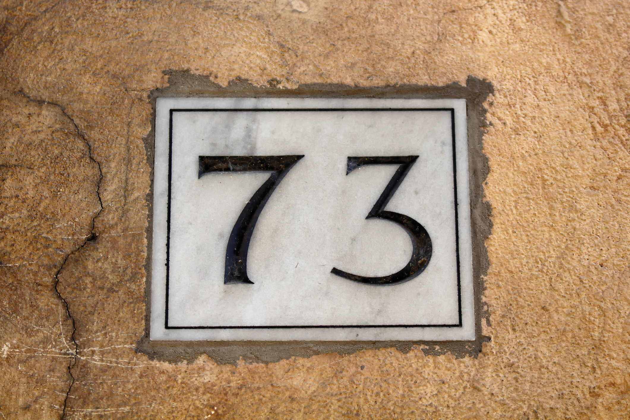 View of a building number (73) in Rome.