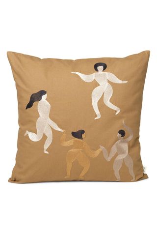 beige pillow with pattern of women dancing