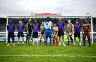 Enfield Town players and WWE NXT UK wrestlers pose following the announcement of their commercial partnership
