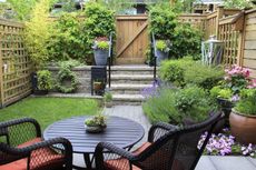 Small Backyard Garden With Furniture Brick Pathway Plants And Flowers