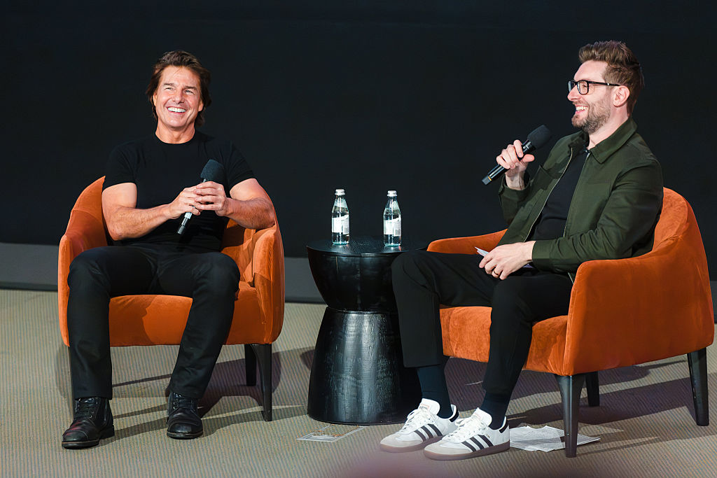 Tom Cruise and moderator Kevin McCarthy speak onstage at the trailer launch event for "Digger" at Warner Bros. Studios on July 09, 2026 in Burbank, California.