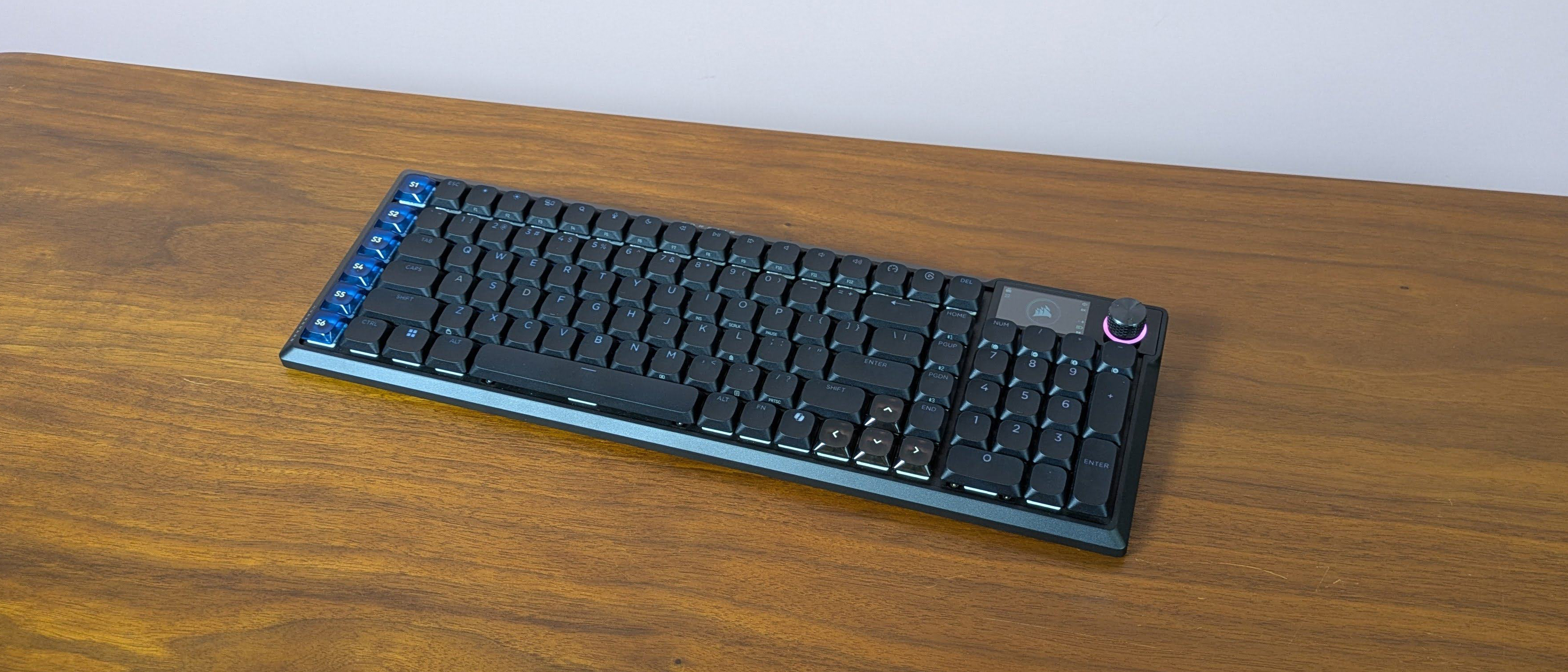 Three-quarter view of Corsair Vanguard Air 99 Wireless+ open on a brown desk 