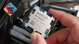 AMD Ryzen 7 9800X3D held between thumb and forefinger