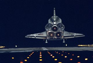 The space shuttle Endeavour glides back to Earth on Jan. 20, 1996, after nine days in space on the STS-72 mission. The orbiter is about to touch down on Runway 15 at the Shuttle Landing Facility at NASA's Kennedy Space Center in Cape Canaveral, Fla.