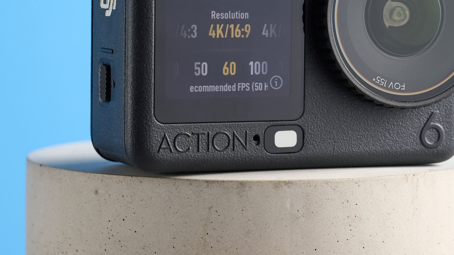 The DJI Osmo Action 6 on a stone surface with a blue background