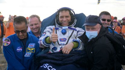 Frank Rubio gives the camera a thumbs up while he is carried by four men
