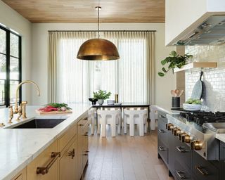 Cozy kitchen with yellow island and gray cabinets