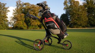 Motocaddy Cube push trolley folded out with bag attached