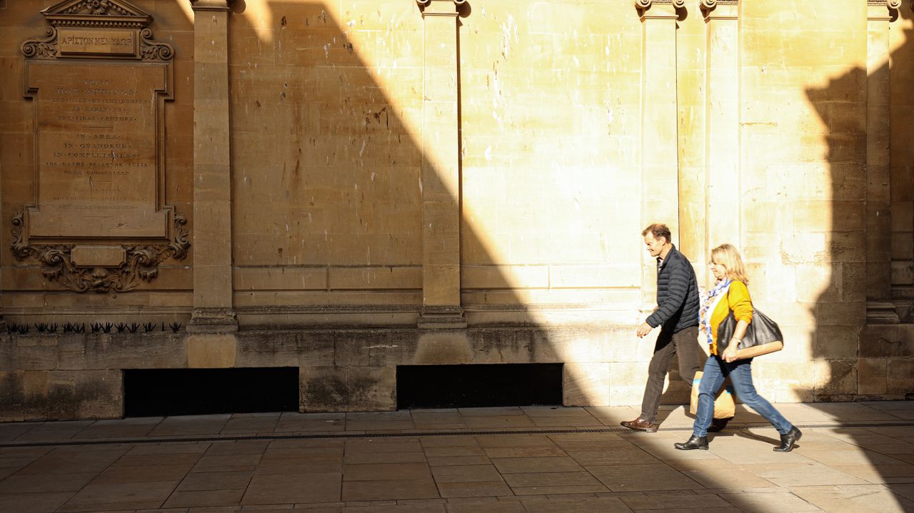 Sample image of people walking in front of limestone buildings