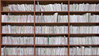 Stacks of papers and documents in an office bookcase