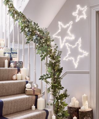 Festive hallway decorated fairy lights, candles and LED star lights