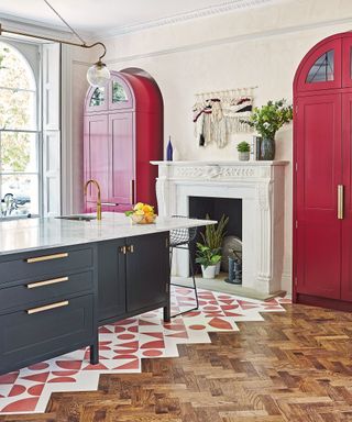 Modern kitchen with parquet and red painted freestanding cabinet