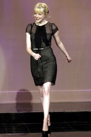 Emma Stone flatters her figure in a classic black mini