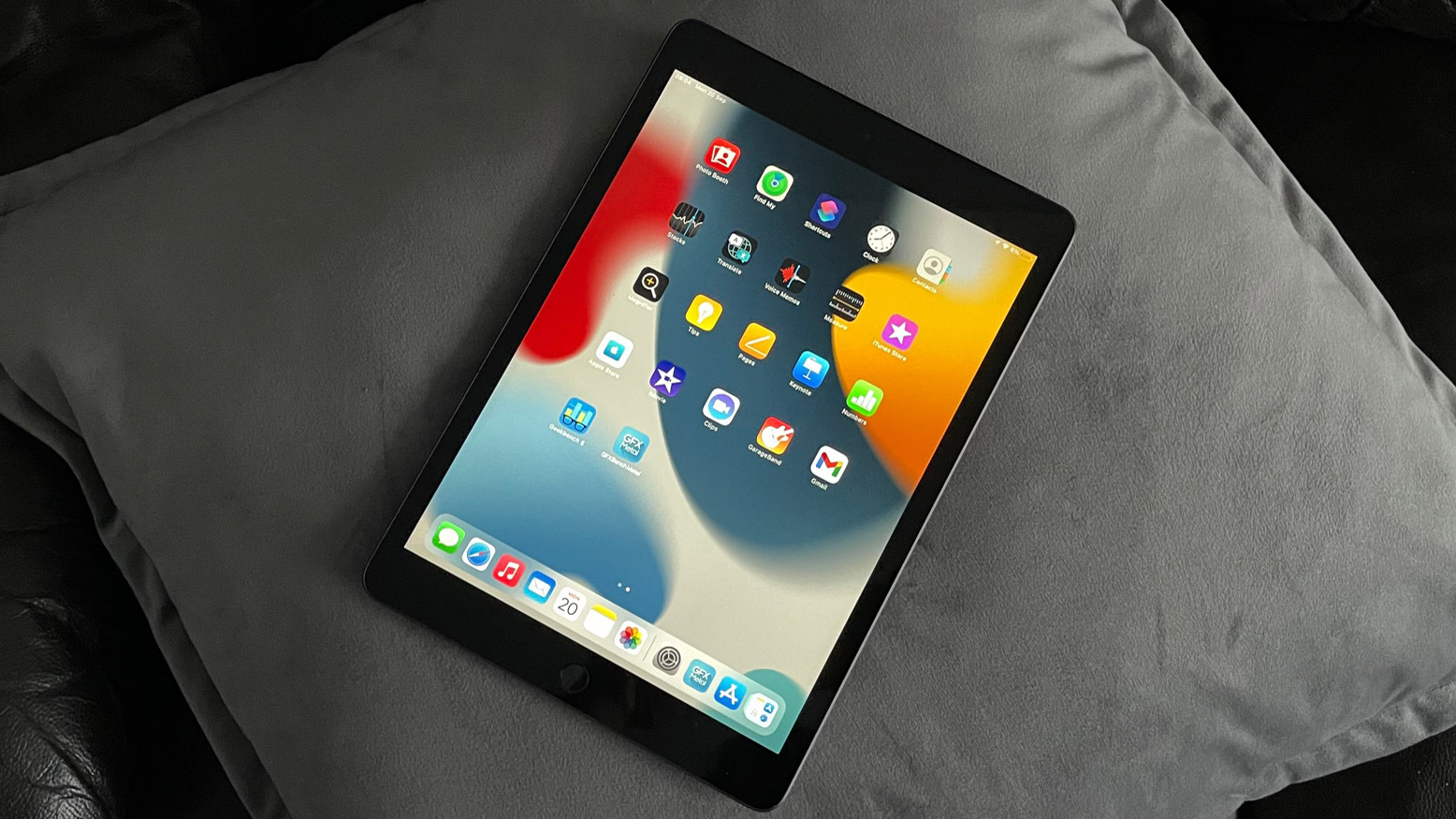 Apple iPad 10.2 (2021) in portrait mode on a grey cushion