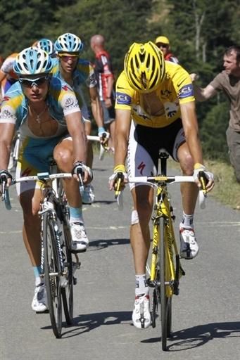 Andy Schleck (Saxo Bank) looks down to figure out what is wrong.