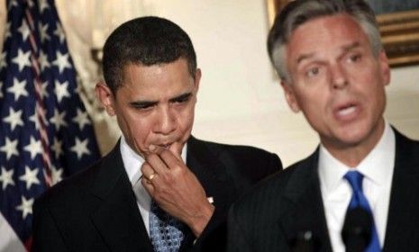 President Obama listens as Jon Huntsman speaks on US-Chinese relations.