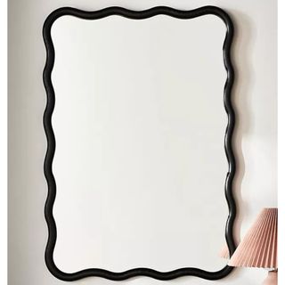 Candace Bathroom Mirror with a black wavy border from Anthropologie