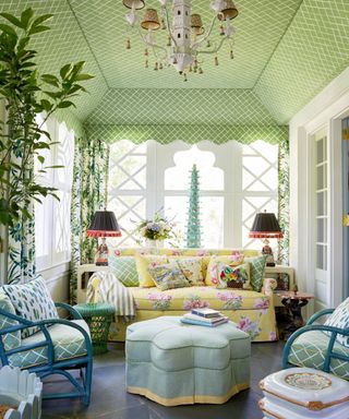 Sitting room with a tented ceiling in the Bahama Court Palm Green fabric with curtains in Jungle Road Palm Green fabric both from Madcap Cottage
