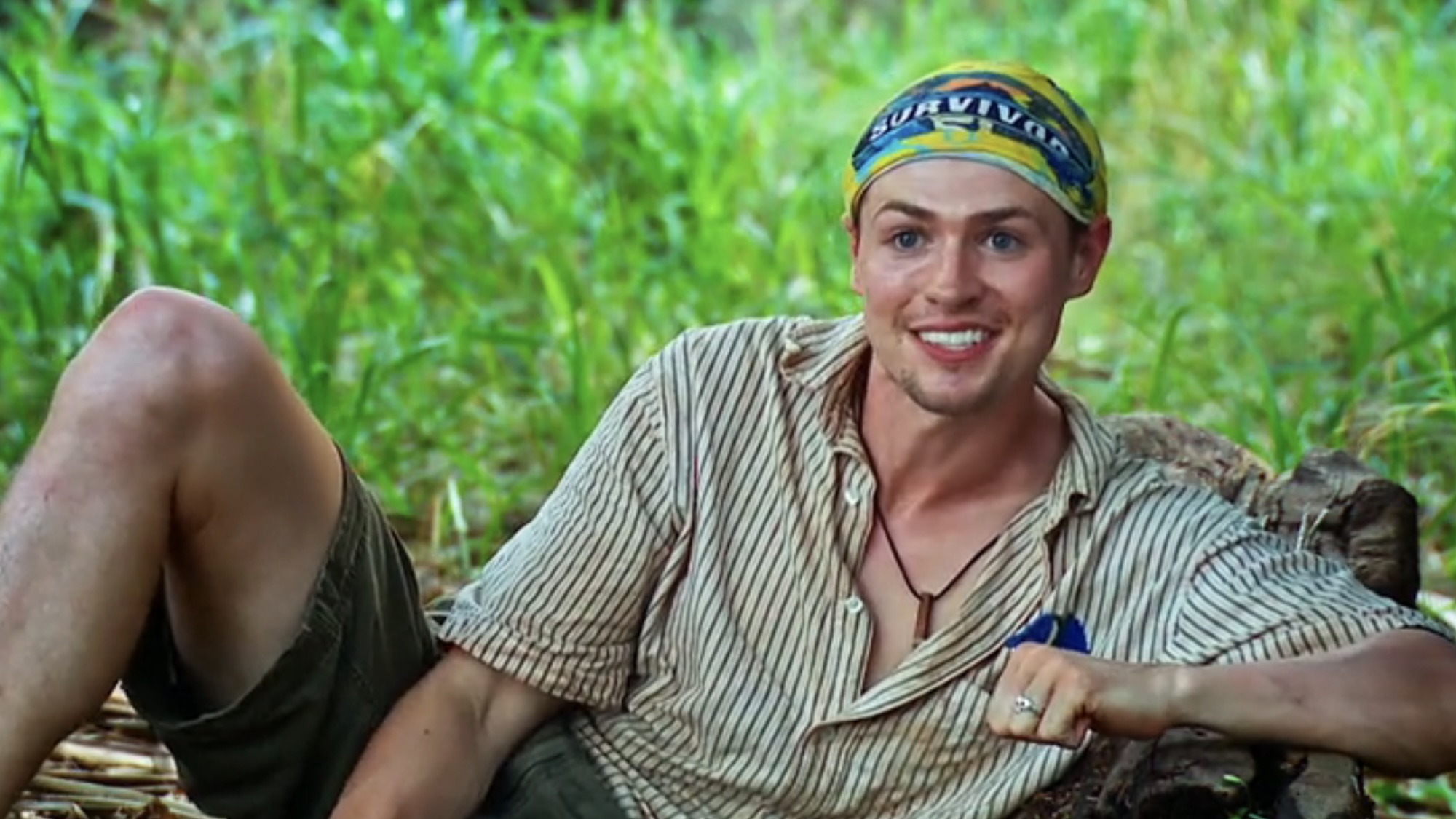 Lewis wearing a yellow buff talking about the Toka tribe in a confessional. 