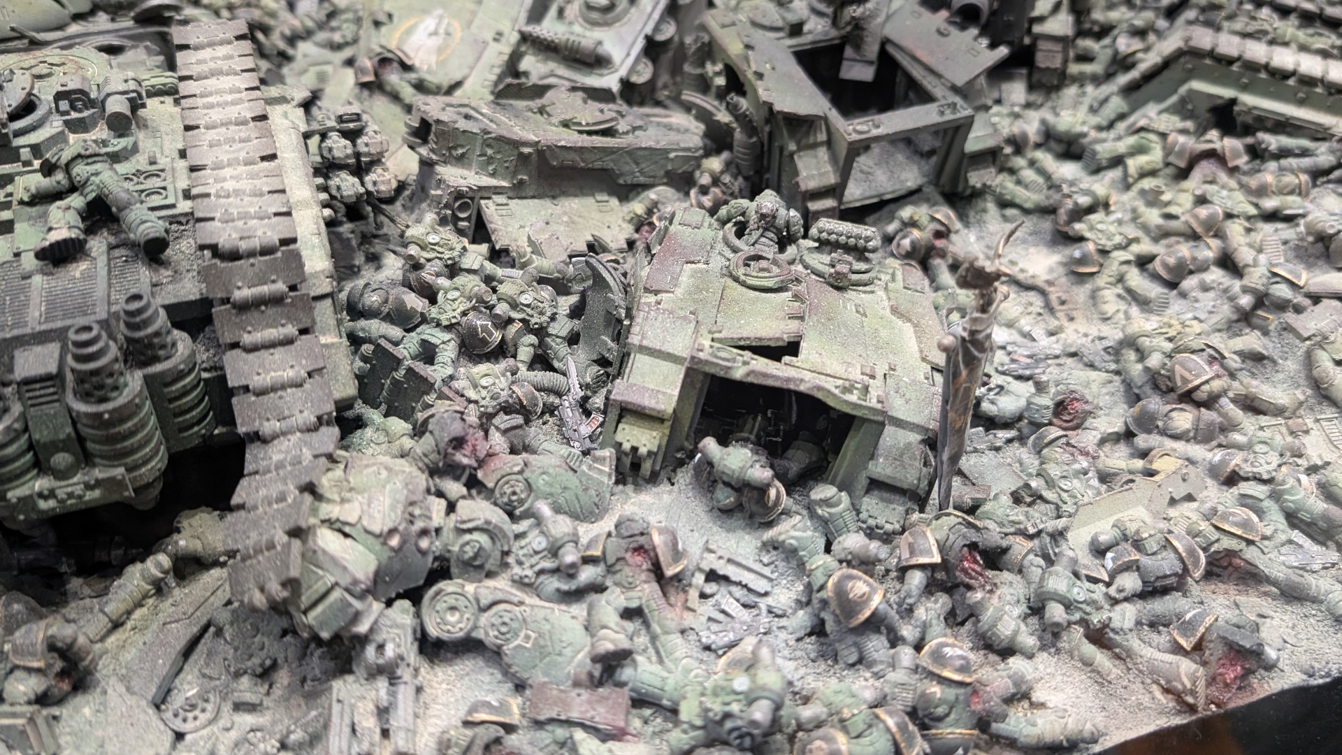 A gruesome array of bodies amongst tanks on a Warhammer 40,000 battlefield