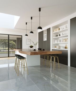 large format polished grey tiles in a modern open plan kitchen with island and wood countertop