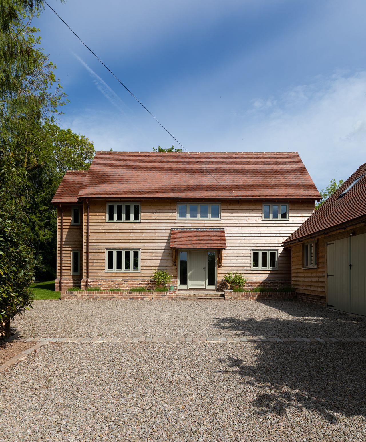 front of oak frame home with matching garage